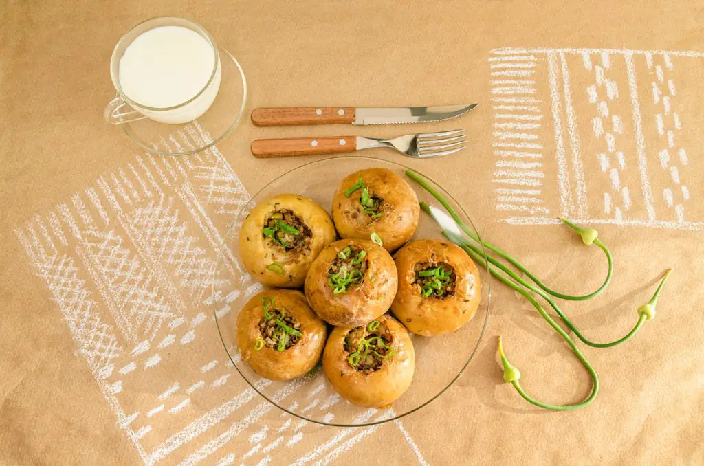 Defrosted and cooked Knishes sitting on a plate ready to eat.